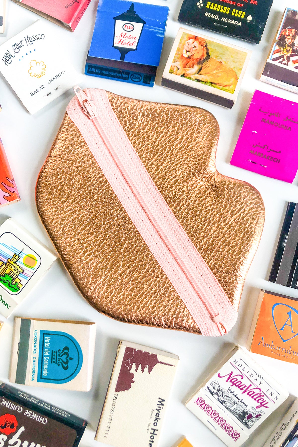 Lip Zip pouch in a flat lay with match books